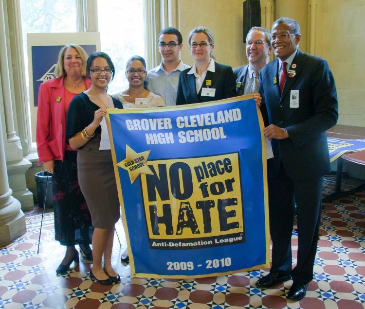 Chairman of NYC Council Education Committee Robert Jackson (far right) and ADL NY Regional Director Ron Meier (second from right) present the Gold Star 'No Place for Hate' banner to students from Grover Cleveland High School. (Aloysio Santos/The Epoch Times)