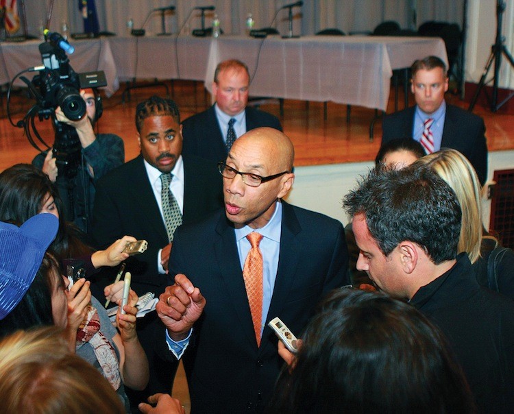 School's Chancellor Dennis Walcott is surrounded by reporters as the Department of Education meeting is overtaken by irate parents and teachers on Tuesday night.  (Ivan Pentchoukov/The Epoch Times)
