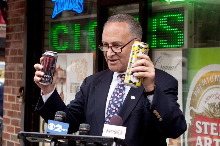 LOADED ENERGY DRINKS: Sen. Charles Schumer holds two brands of alcoholic, caffeinated beverages he says are being marketed towards young people at a press conference on Sunday.  (Henry Lam/The Epoch TImes)