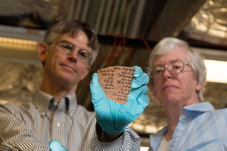 Brian Muhs and Janet Johnson, researchers at the University of Chicago's Oriental Institute, display a pottery piece with Demotic writing. (University of Chicago) 