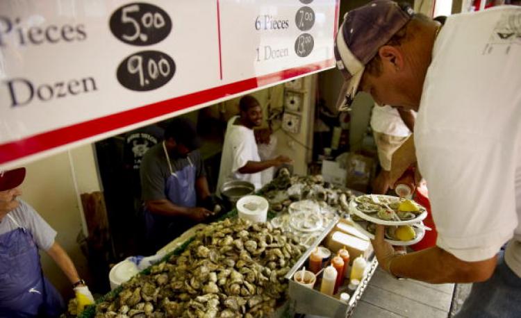 A man eats oysters on the half shell at the Washington Seafood Market. Researchers found large quantities of contaminants in shellfish and soil in the Gulf of Mexico. (Jim Watson/AFP/Getty Images)