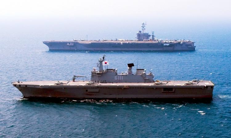 The South Korean amphibious landing ship ROKS Dokdo and the aircraft carrier USS George Washington during readiness exercise on July 27, 2010. (Adam K. Thomas/U.S. Navy via Getty Images)