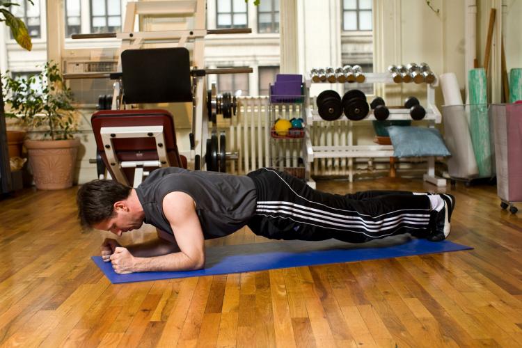 Plank push-ups strengthen, shape, and open up the shoulders.  (Henry Chan/The Epoch Times, Space Courtesy of Fitness Results)
