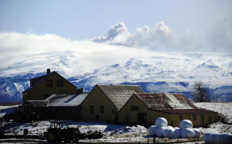 A farm is pictured in front of smoke and ash billowing from the Eyjafjallajokull volcano near Porolfsell, on April 21, 2010. The sky is clearing and many airports are now open for business. (Emmanuel Dunand/AFP/Getty Images)