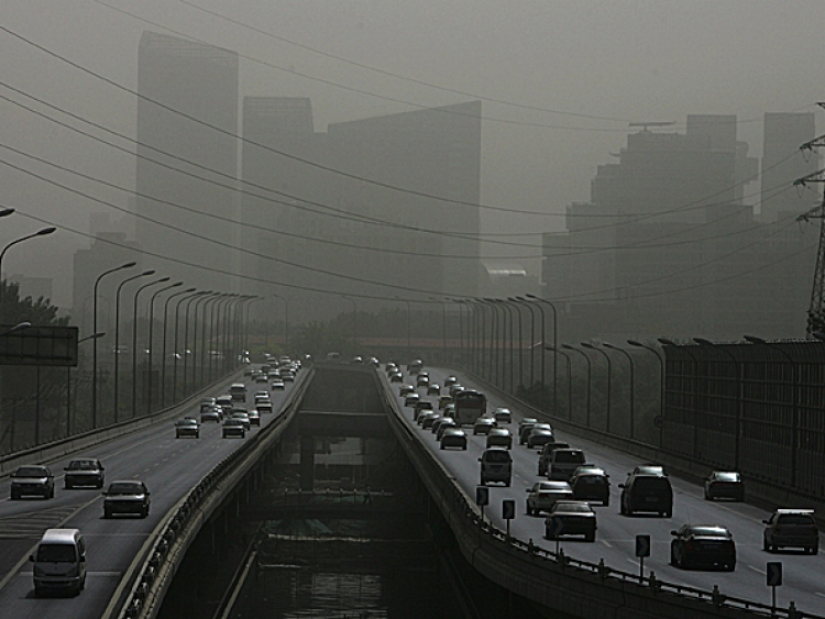 Vehicles drive on a street shrouded with smog in Beijing, China. Pollution levels in Beijing hit the top of the scale in late May, prompting a government warning for residents with respiratory problems to stay indoors. (Guang Niu/Getty Images)