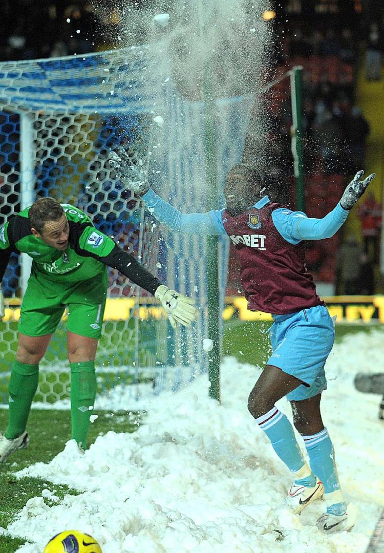 PLAYING IN THE SNOW: West Ham's Carlton Cole tries to make the best of a trying time for players in the English Premier League. (Andrew Yates/AFP/Getty Images)