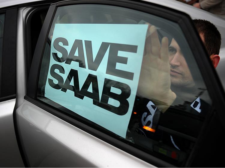 A man puts a 'Save Saab' sign on his car during a demonstration in front of a former showroom of Saab in Sofia, Bulgaria, part of the world-wide Saab Support Convoy campaign, January 16, 2010. (Nikolay Doychinov/AFP/Getty Images)