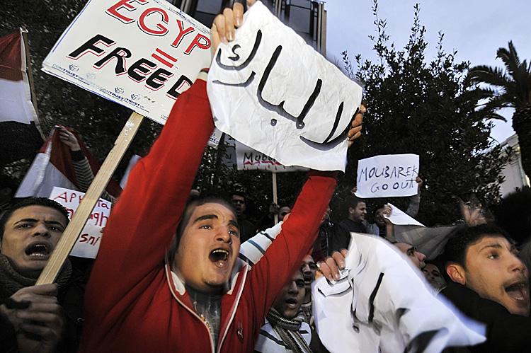 Egyptians living in Athens carry placards reading ''Mubarak go'' and ''Egyptian equal freedom'' during a protest against Egyptian president Hosni Mubarak's regime, outside the Egyptian embassy in Athens, on January 28, 2011. Demonstrations in Egypt, inspired by the 'Jasmine Revolution' in Tunisia, have swelled into the largest uprising in three decades, sending shockwaves across the region. (Louisa Gouliamaki/AFP/Getty Images)