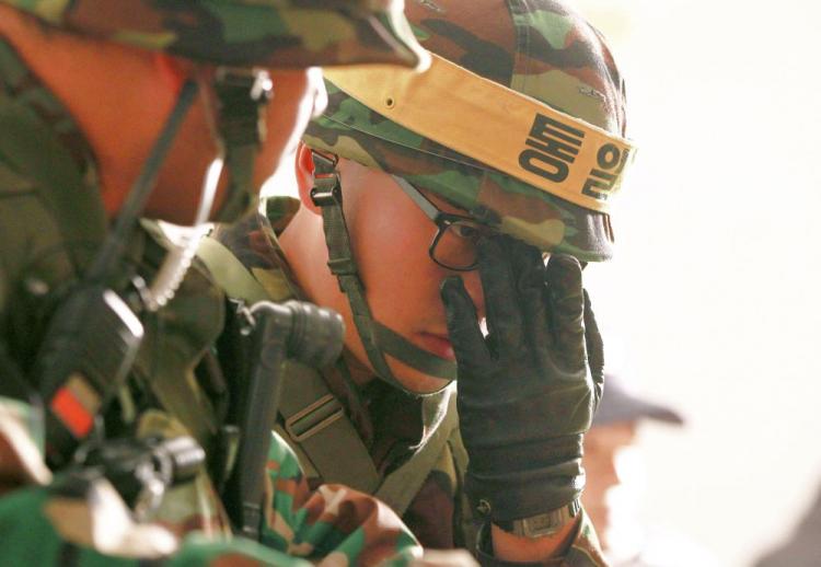 South Korean soldiers take shelter in a bunker during a live-fire exercise on Yeonpyeong island near the disputed waters of the Yellow Sea on Dec. 20. South Korea held a live-fire military drill on a border island and scrambled fighter jets despite North Korean threats of deadly retaliation, as U.N. diplomacy on the crisis broke down.  (Korea Pool/AFP/Getty Images)