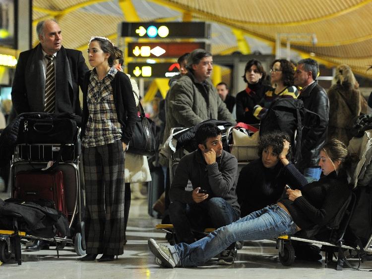 Passengers wait at Barajas airport on December 3, 2010 in Madrid, Spain. A massive walk out by air traffic controllers on the eve of a holiday has caused flight problems all over Spain. (Jasper Juinen/Getty Images)