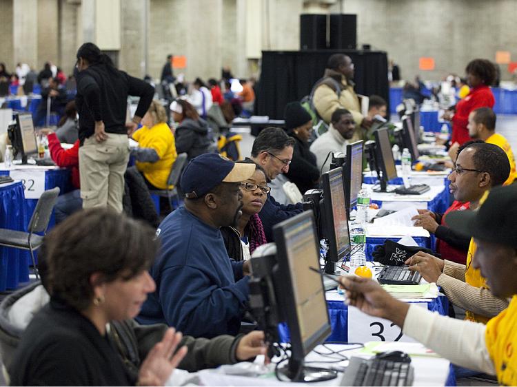 Homeowners sit with counselors with the Neighborhood Assistance Corporation of America to help them modify their mortgages at the Jacob Javits Convention Center on December 12, 2009 in New York City. Thousands of homeowners around the country have used NACA to lower their house payments and save their homes. (Michael Nagle/Getty Images)