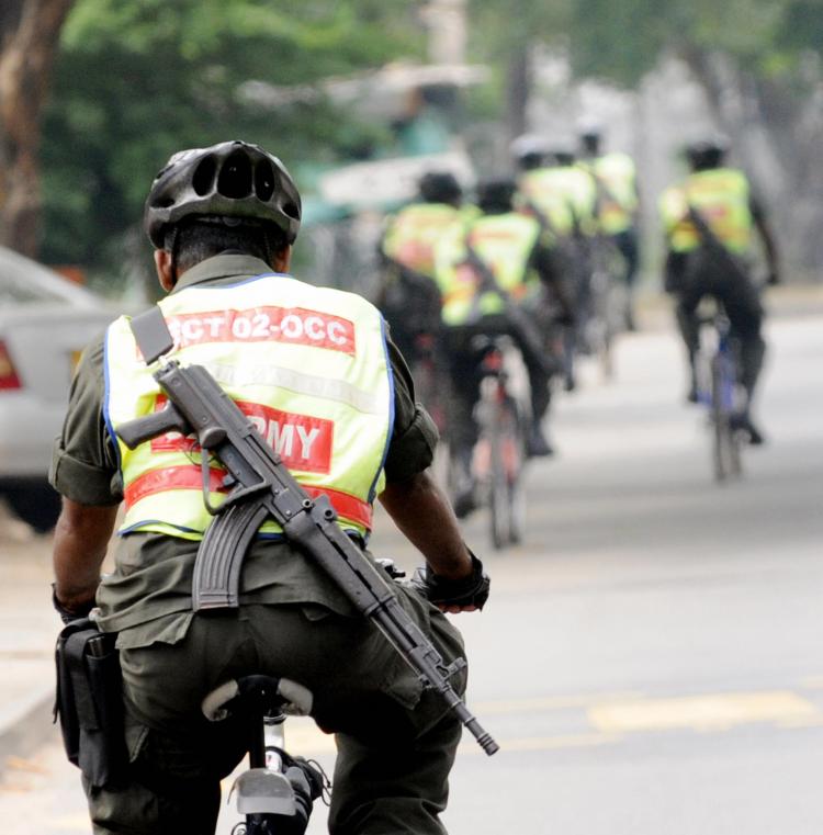 Sri Lankan security forces personnel patrol on bicycles in Colombo on January 26, 2009 a day after the army captured the Tamil Tigers' last outpost in Mullaittivu. Sri Lanka's army chief Sarath Fonseka has vowed to finish the decades old war in April. (Ishara S. KODIKARA/AFP/Getty Images)