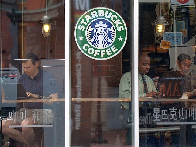 People use their laptop computers at a Starbucks in Washington, D.C.