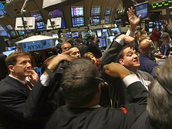 In this Sept. 17, 2008, file photo, anxious traders worked the floor of the New York Stock Exchange following the U.S. government's bailout of American International Group, Inc. (AIG). On Sunday, Treasury announced the sale of $18 billion in AIG stock, on its way to recovering billions in taxpayer funds used to rescue the insurance giant and stabilize the financial system.  (Mario Tama/Getty Images)