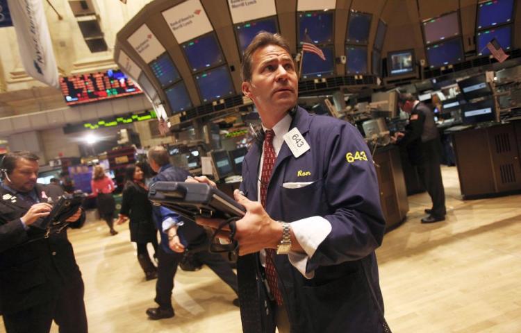 Traders work on the floor of the New York Stock Exchange before the closing bell Nov. 29 in New York City. The Dow finished down 39 points to close at 11,052 as worries over the Irish bailout continued. On Sunday, the IMF and EU approved a bailout to shore up the finances of Ireland's government-owned banks. (Mario Tama/Getty Images)