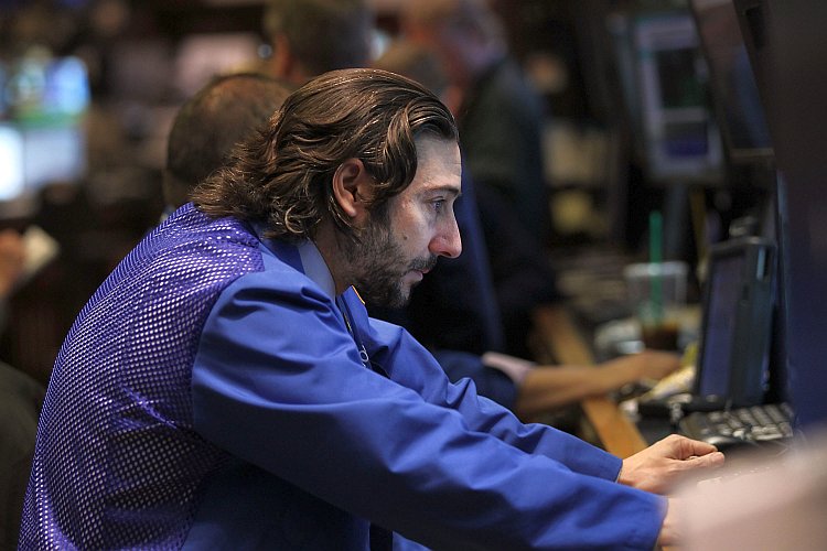 A trader looks at his screen at the New York Stock Exchange