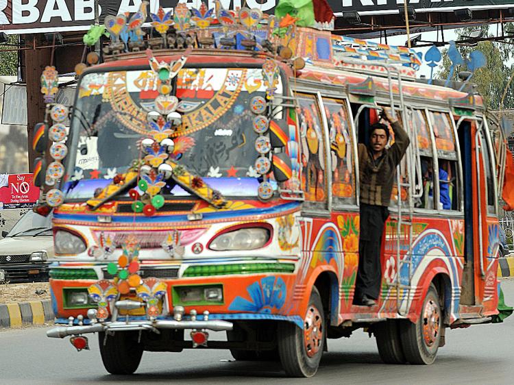Pakistani commuters travel in a bus through the city of Peshawar.  (Saeed Khan/AFP/Getty Images)