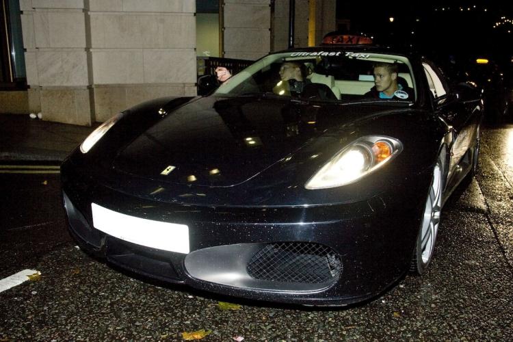 Virgin's new Ferrari ultra-fast taxi was caught, ahead of its official launch, by an Epoch Times photographer. The ultra-fast taxi fleet are now on the streets of London to promote Virgin,s new 100Mbps Broadband service. The license plate has been blanked out in the image.  (Simon Gross/The Epoch Times)