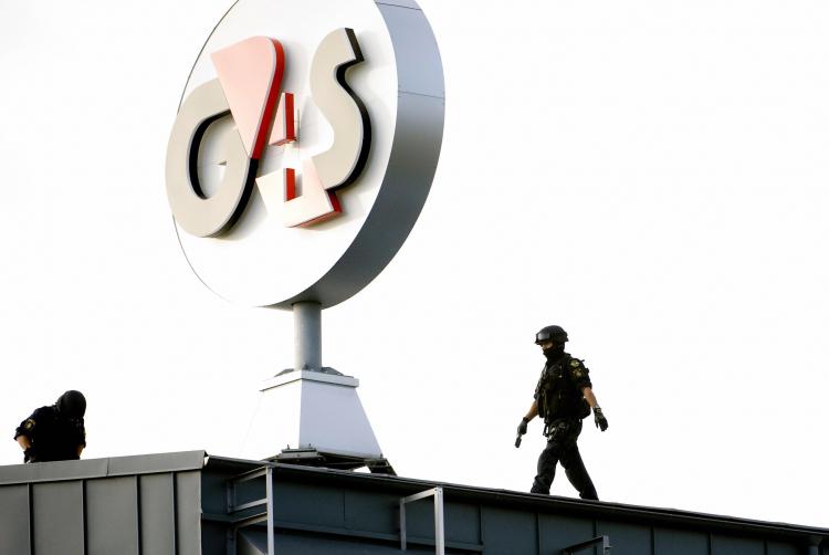 A police SWAT team inspects the roof of the G4S cash depot in Vastberga, Stockholm on Wednesday, after robbers used a helicopter to carry out a robbery at the cash depot. (Pontus Lundahl/AFP/Getty Images)