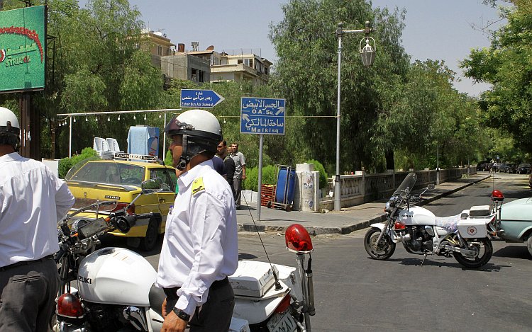 Syrian police guard the road