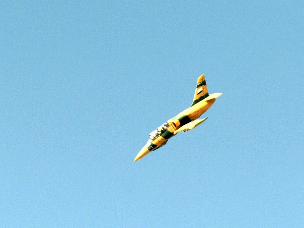 A Syrian army fighter jet flies over the northern city of Aleppo on October 13, 2012. Syria's military has stepped up its use of the widely banned cluster bombs during battles against rebel forces. (Tauseef Mustafa/AFP/GettyImages)