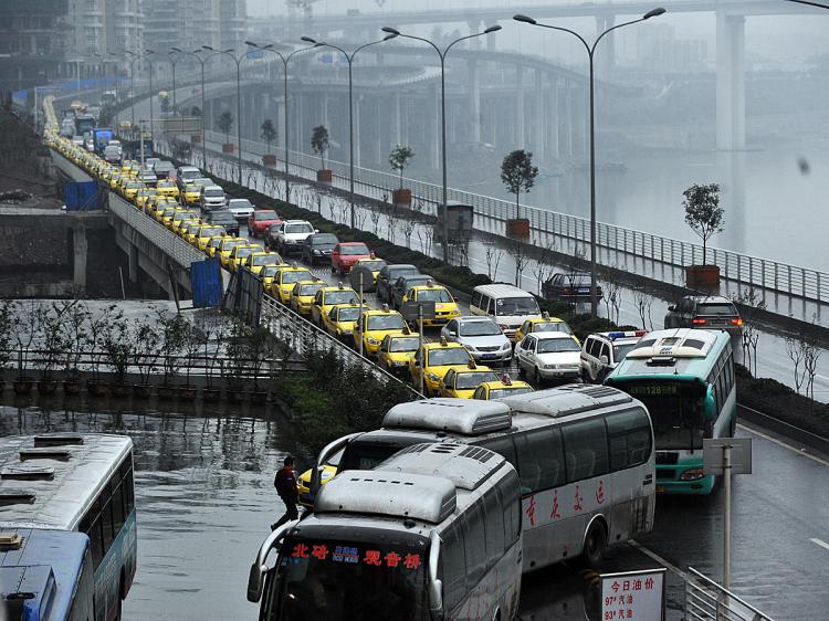 Taxis queue up to get their fuel tanks filled in southwest China's Chongqing municipality on Nov. 18. Taxi drivers went on strike in early November to protest shortages of fuel and competition from unlicensed cabs, among other issues. The drivers on strike became some of the targets of Bo Xilai's 'hitting the black' campaign, said to be against gangsters. (AFP/Getty Images)