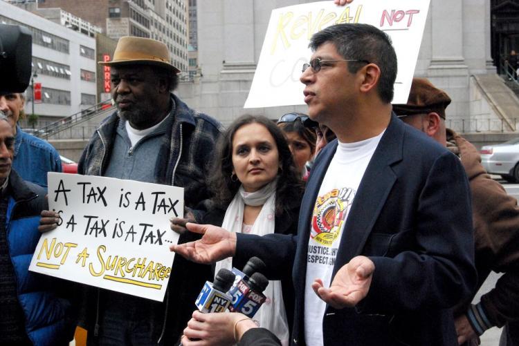 New York Taxi Workers Alliance Committee Member Victor Salazar (R) calls a new tax on cab rides that went into effect on Sunday 'oppression.' (Catherine Yang/The Epoch Times)