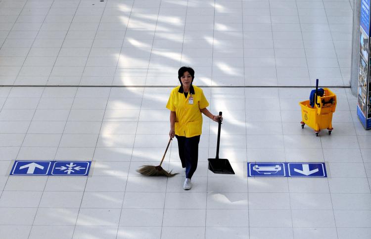 A worker cleans the international arrival lounge after anti-government protesters left Suvarnabhumi international airport in Bangkok on December 3, 2008. (SAEED KHAN/AFP/Getty Images)