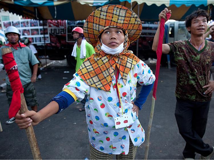 DRESSING UP: Antigovernment protesters continue their occupation of one of Bangkok's shopping districts in their conflict with the Thai government. They have swapped their signature red shirt clothing for more neutral colors to avoid being an easy target for Thai security forces, who they say are planning to crack down on them.Paula Bronstein/Getty Images (Paula Bronstein/Getty Images)