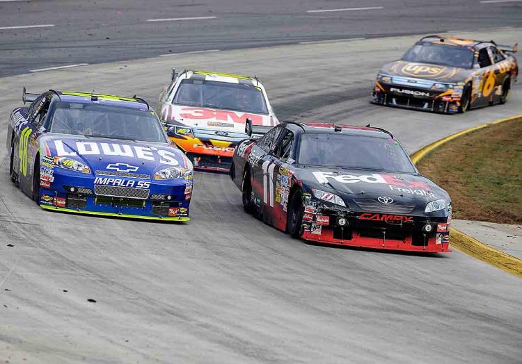 Denny Hamlin in the #11 FedEx Freight Toyota, leads Jimmie Johnsonn the #48 Lowe's Chevrolet, Greg Biffle in the #16 3M/Filterete Ford, and David Ragan in the #6 UPS Ford, during the NASCAR Sprint Cup Series TUMS Fast Relief 500 at Martinsville Speedway on October 25, 2009 in Martinsville, Virginia. (John Harrelson/Getty Images)
