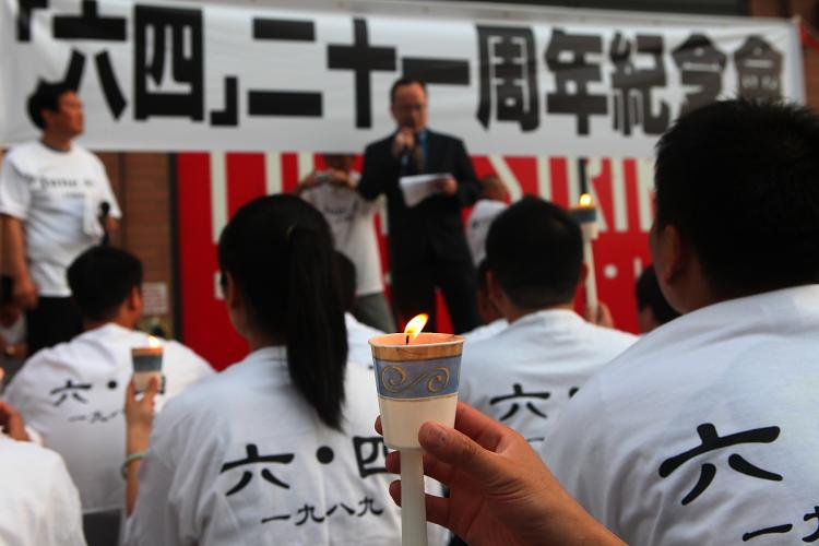 LONGING FOR JUSTICE: Listeners hold candles in remembrance of the Tiananmen Square Massacre at the Chinese Consulate on 42nd Street and 12th Avenue on Friday. (Gary Du/The Epoch Times)