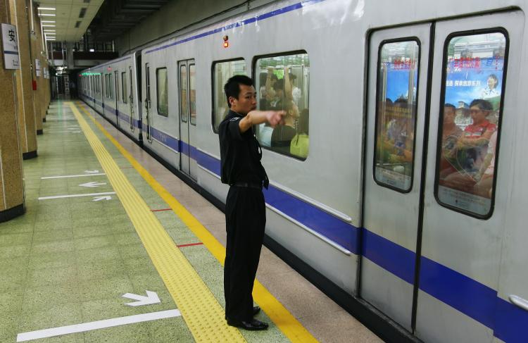 Police in Hebei Province have admitted to placing photos of Falun Gong founder Li Hongzhi on the ground, forcing commuters to step on them in order to pass. (Getty Images)