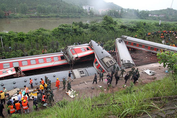 Rescuers check the twisted wreckage of a train that derailed in Dongxiang County, in eastern China's Jiangxi Province. The train was headed from Shanghai to the tourist city of Guilin. (AFP/Getty Images)