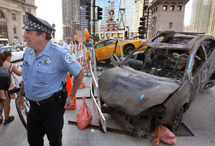 'TRANSFORMERS 3' ACCIDENT: A woman was reportedly injured during a stunt on Wednesday night. Pictured above, a Chicago police officer stands guard in front of a staged car accident on the Michigan Avenue bridge during the filming of the movie Transformers 3 in July. (Scott Olson/Getty Images)
