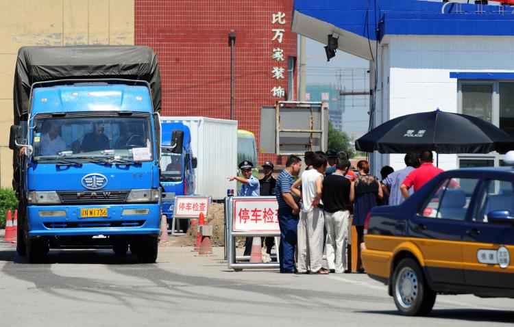 Truckers get their registration checked. In some areas in China, drivers are forced to pay fines that sometimes bought exemption from traffic law violation for several months. (Frederic J. Brown/AFP/Getty Images)