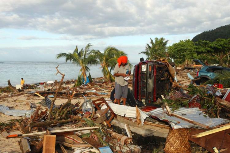 A Samoan man searches amongst the debris at the beach following an 8.3 on the Richter scale strong earthquake which struck on September 30 in Lalomanu, Samoa. (Phil Walter/Getty Images)