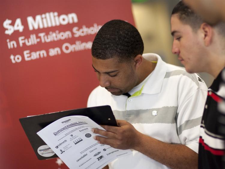 Brandon Hemphill fills out a form as Jesus Cisneros looks on during a stop on the Empowerment Tour September 4, 2009 in San Francisco, California.  (David Paul Morris/Getty Images)