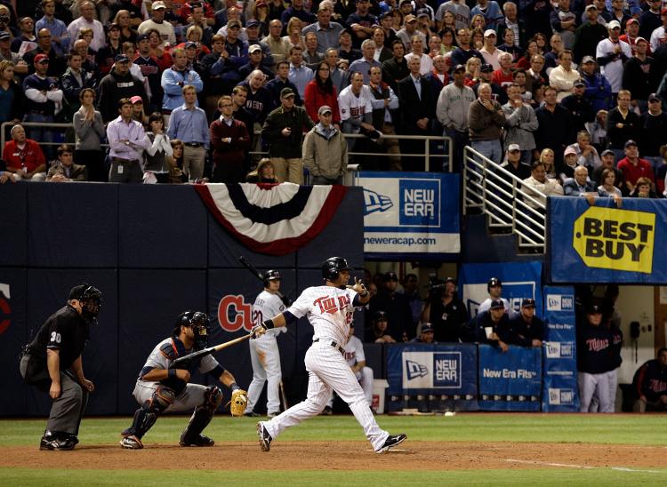 WALK OFF SINGLE: Alexi Casilla of the Minnesota Twins drives in game-winning run as the Twins defeat the Detroit Tigers to win the American League tiebreaker 6-5 in 12 innings. (Jamie Squire/Getty Images)