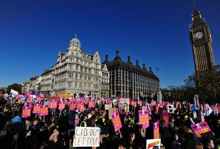 Demonstrators hold placards during a student protest march in central London on November 10, 2010.  (Carl Court/AFP/Getty Images)