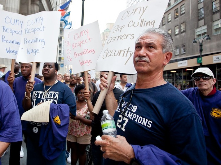 BUDGET CUTS: Security officers gathered in front of the CUNY Graduate Center on Wednesday to rally against CUNY budget cuts. Many spoke about the impact of the cuts on their families. (Amal Chen/The Epoch Times)