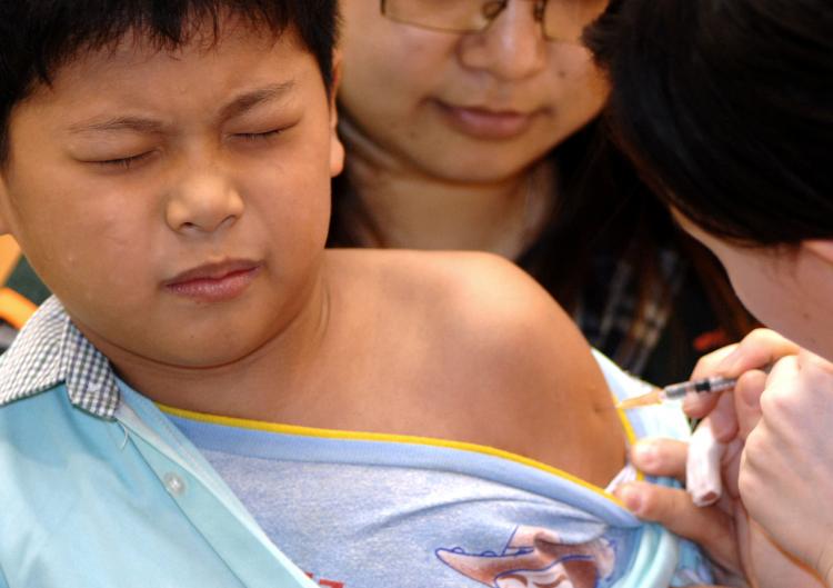 FLU JAB: A boy receives an injection of swine flu vaccine.