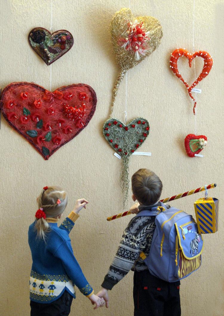Beyond candy, valentines, and kisses, give your child a lasting gift to teach them how to form kind, caring, and nurturing relationships. (Viktor Drachev/Stringer/AFP/Getty Images)