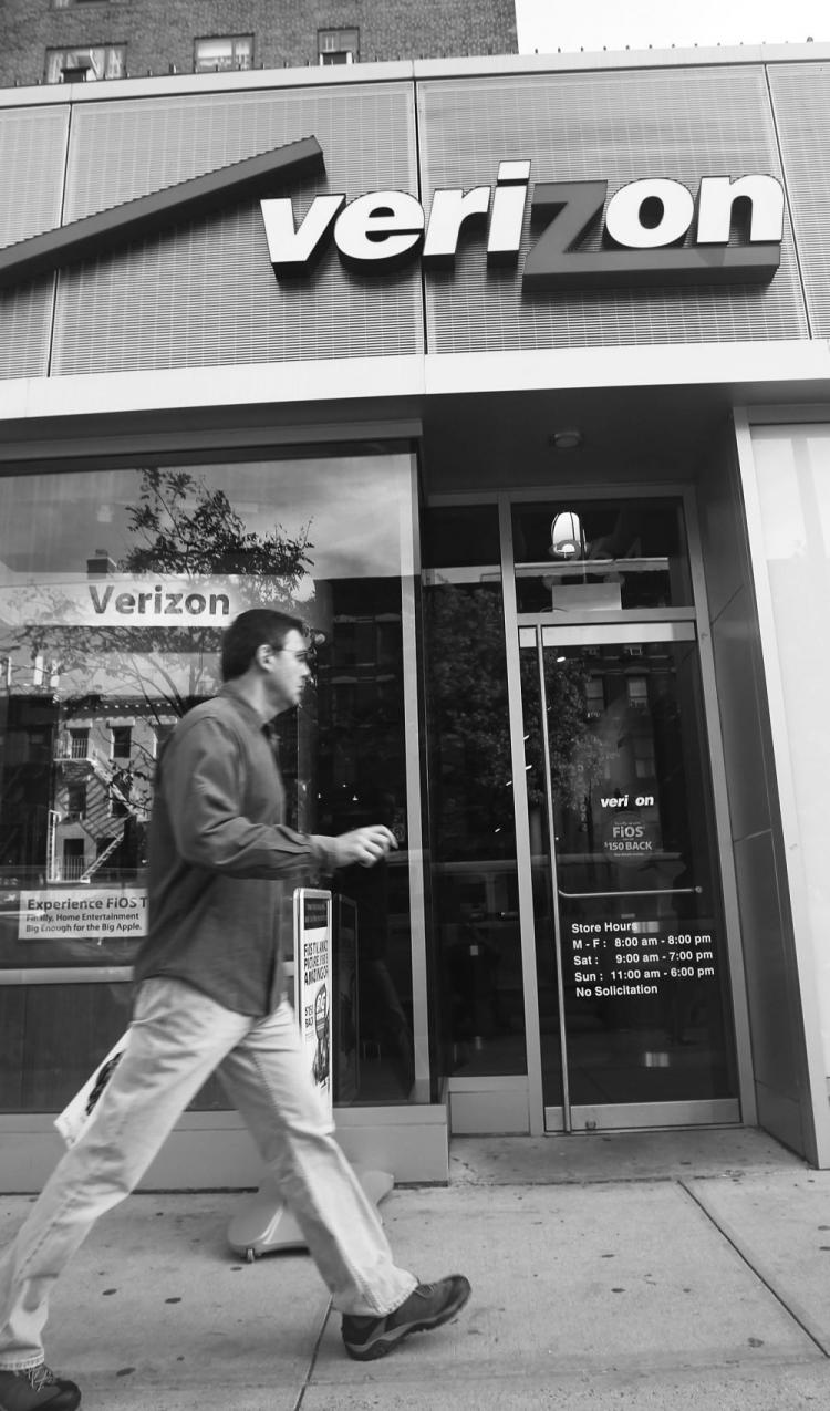 A man walks by a Verizon store Monday in New York City. (Mario Tama/Getty Images )