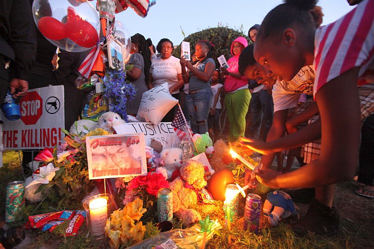 Supporters gather during a candelight vigil at a memorial to Trayvon Martin