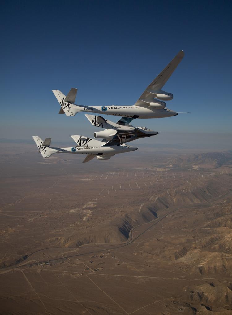 Virgin Galactic's suborbital spacecraft, VSS Enterprise, being carried by the WhiteKnightTwo mothership during a test flight over the Mojave Desert in California. (Mark Greenberg)