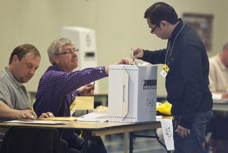 A voter casts his ballot in Canada's recent federal election on May 2 at a polling station in Calgary. Statistics Canada revealed that 40 percent of Canadians did not vote.(Geoff Robins/AFP/Getty Images)