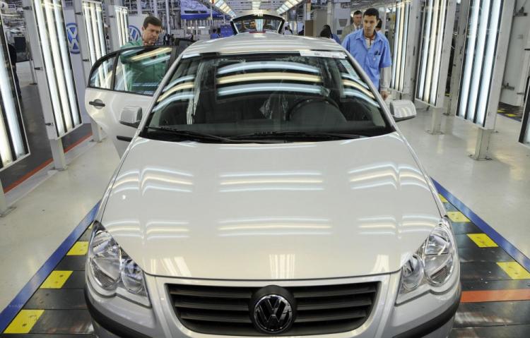 Volkswagen employees work on cars on the assembly line of the plant in Sao Paulo. (Michael Kappeler/AFP/Getty Images)
