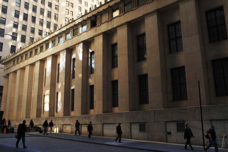 People walk towards Wall Street in the financial district in New York City. The U.S. Securities and Exchange Commission has expanded the number of stocks subject to its circuit breakers rule. (Spencer Platt/Getty Images)