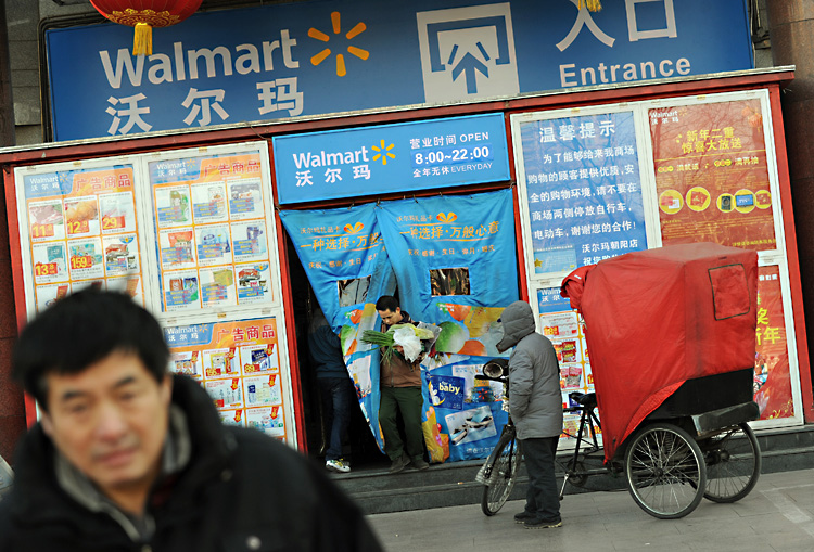 Chinese shoppers leave a Walmart store