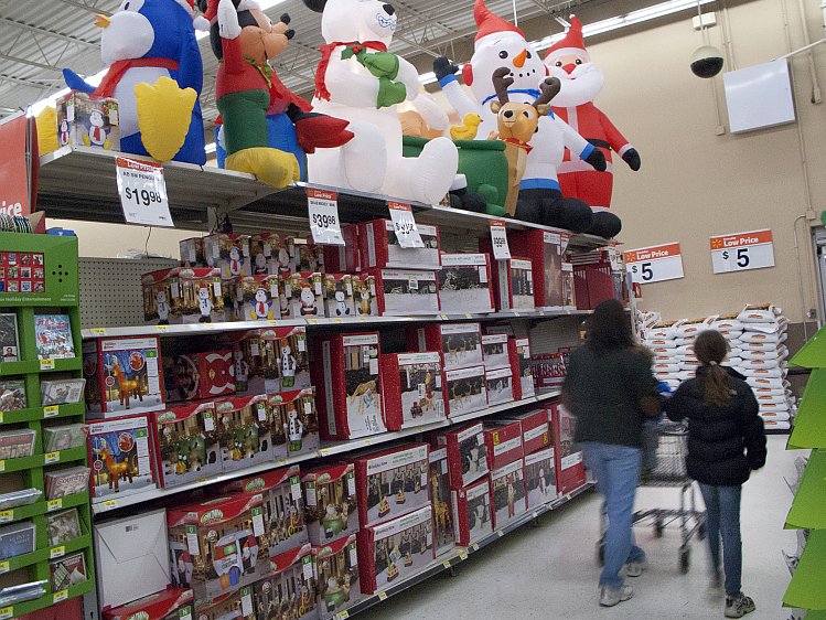 Customers walk past Christmas items at a Walmart store on November 17 in Norwalk, Connecticut. Black Friday shoppers will need to shop earlier this year to bag those amazing bargains. At Wal-Mart, Black Friday starts at 8 p.m. on Thanksgiving this year.